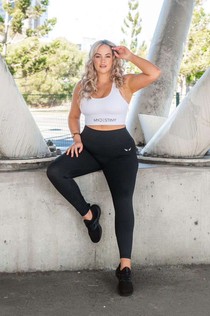 model posing white sports bra. Leggings. Activewear